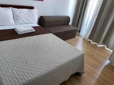 a bedroom with a bed and a chair in a room at Azure Urban Resort a13 near airport wavepool in Manila