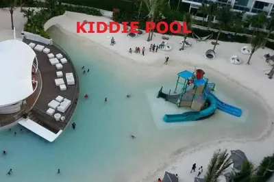 a water park with a slide and people in the water at Azure Urban Resort a13 near airport wavepool in Manila