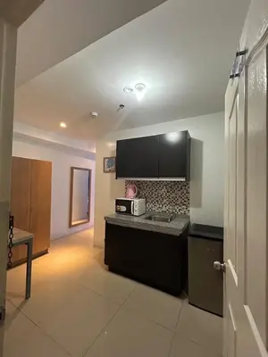 a kitchen with a stove and a microwave at Melbourne makati in Manila