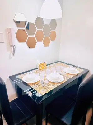 a blue table with plates and glasses on it at Shabby Chic & Contemporary Condo in Manila