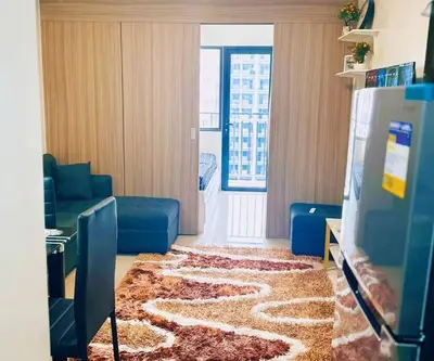 a living room with a large rug on the floor at Shabby Chic & Contemporary Condo in Manila