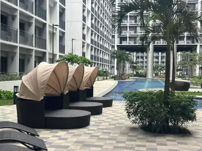 a row of benches in front of a building at Shabby Chic & Contemporary Condo in Manila