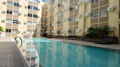 a swimming pool in front of a building at J Studio - Fast WiFi, 55