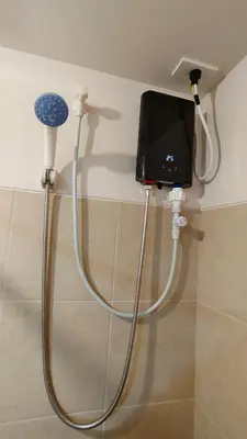a shower head and a tv on a wall at J Studio - Fast WiFi, 55