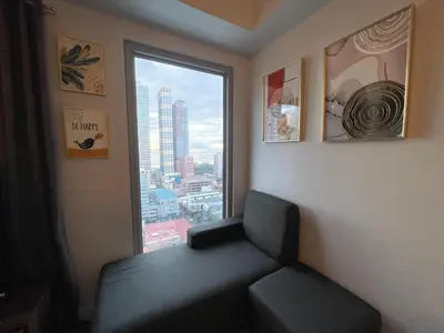 a room with a chair and a large window at 8 Adriatico - 1 Bedroom with 1 Parking Space near SLMEC, PGH and US Embassy in Manila