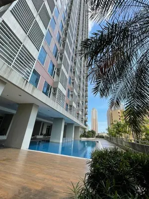 a building with a swimming pool in front of a building at 8 Adriatico - 1 Bedroom with 1 Parking Space near SLMEC, PGH and US Embassy in Manila