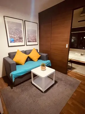 a living room with a couch and a table at Destina @Air Residences Makati, Metro Manila in Manila