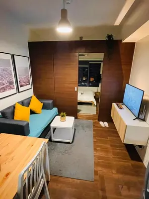 a living room with a couch and a table at Destina @Air Residences Makati, Metro Manila in Manila