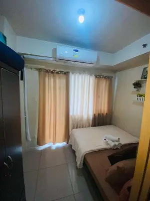 a small bedroom with a bed with a stuffed animal on it at Triple 3D Shell Residences in Manila