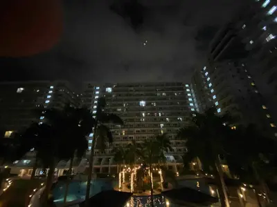 a view of a city at night with buildings at Triple 3D Shell Residences in Manila