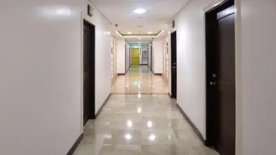 a hallway of a building with two doors and a hallwayngth at Experience OCEAN VIEW Rooms in The Heart Of Manila, Enjoy FREE ACCESS To The POOL, SAUNA, PLUS MASSAGE PROMO In Prime Location Near The US Embassy, NAIA, Makati, BGC, Mall of Asia, And Chinatown This Is A Limited-Time Offer, Book Now in Manila