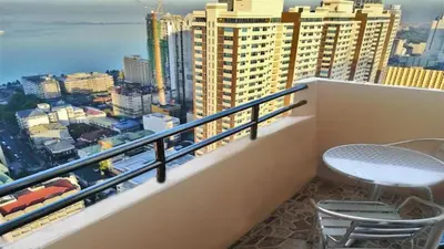 a balcony with a chair and a view of the city at Experience OCEAN VIEW Rooms in The Heart Of Manila, Enjoy FREE ACCESS To The POOL, SAUNA, PLUS MASSAGE PROMO In Prime Location Near The US Embassy, NAIA, Makati, BGC, Mall of Asia, And Chinatown This Is A Limited-Time Offer, Book Now in Manila