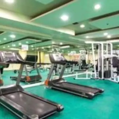 a gym with two treadmills and a treadmill at Experience OCEAN VIEW Rooms in The Heart Of Manila, Enjoy FREE ACCESS To The POOL, SAUNA, PLUS MASSAGE PROMO In Prime Location Near The US Embassy, NAIA, Makati, BGC, Mall of Asia, And Chinatown This Is A Limited-Time Offer, Book Now in Manila