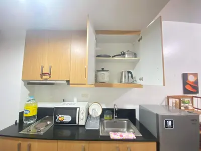 a small kitchen with a sink and a microwave at YUYANS Staycation Shell Residences in Manila