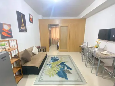 a living room with a couch and a table at YUYANS Staycation Shell Residences in Manila