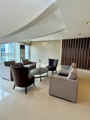 a living room with couches and chairs and a table at 2 BR Condo SMDC Breeze Residences in Manila