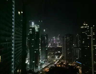 a night view of a city with tall buildings at Simple Yet Lovely 2BR Unit in Acqua Private Residences in Manila