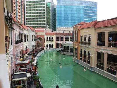 a green river in the middle of a city at Venice Luxury Residences, Tower B, McKinley Hill, Taguig in Manila