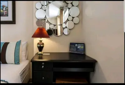a bedroom with a table with a lamp and cups on the wall at Venice Luxury Residences, Tower B, McKinley Hill, Taguig in Manila