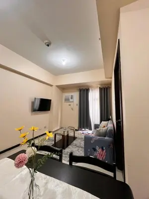 a living room with a couch and a table at Bayview near PICC CCP starcity OKADA Airport MOA in Manila