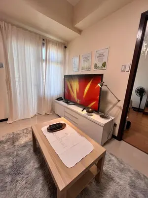 a living room with a television and a coffee table at Bayview near PICC CCP starcity OKADA Airport MOA in Manila