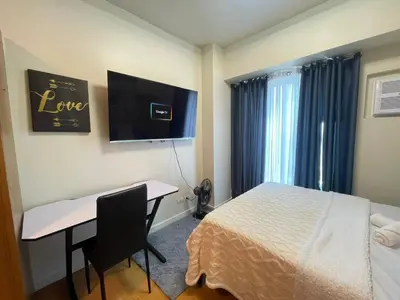 a hotel room with a bed and a desk and a computer at Manila Bay Views City Delights Stay near St Lukes and US Embassy in Ermita Manila in Manila