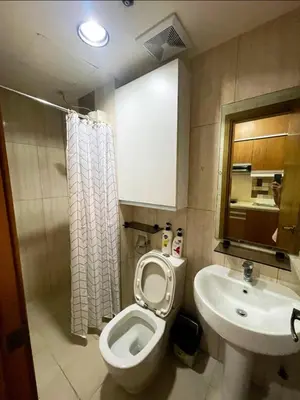 a bathroom with a toilet and a sink at Manila Bay Views City Delights Stay near St Lukes and US Embassy in Ermita Manila in Manila