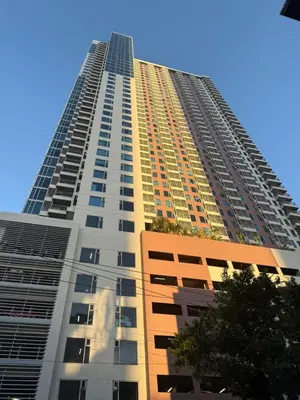 a tall building with a blue sky in the background at Manila Bay Views City Delights Stay near St Lukes and US Embassy in Ermita Manila in Manila