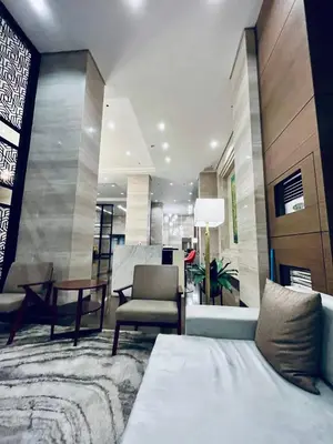 a living room with a couch and a chair at Sundawn RadianceManilaBay in Manila
