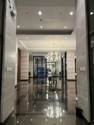 a person walking down a hallway in a building at Sundawn RadianceManilaBay in Manila