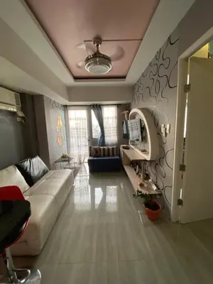 a living room with a couch and a table at Avida Tower San Lorenzo in Manila