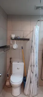 a bathroom with a toilet and a shower curtain at DG CONDOTEL @MANHATTAN PLAZA T2 STUDIO WITH BALCONY , 50 INCH TV AND UNLI WIFI @Araneta Cubao Quezon City Philippines in Manila