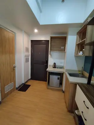 a small kitchen with a sink and a door at Yuanhang 1508 in Manila