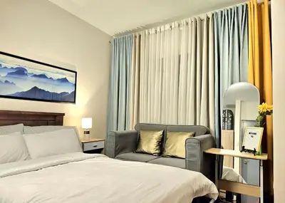 a hotel room with a bed and a chair at Guest Favorite House in Biñan in Biñan
