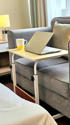 a laptop on a table next to a couch at Guest Favorite House in Biñan in Biñan