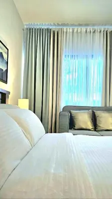 a hotel room with two beds and a window at Guest Favorite House in Biñan in Biñan