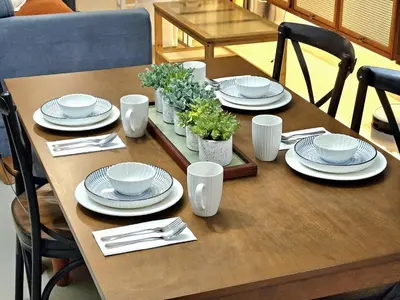 a wooden table with plates and dishes on it at Guest Favorite House in Biñan in Biñan