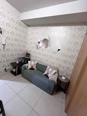 a living room with a couch in a room at JAL's Cozy Haven in Manila