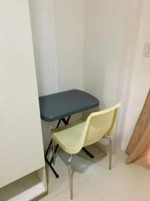a blue table and a yellow chair in a room at SMDC Light Residences Condominium in Manila