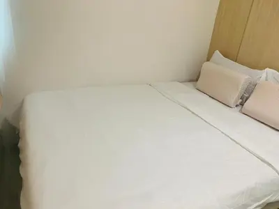 a white bed with two pillows in a room at SMDC Light Residences Condominium in Manila