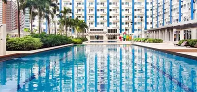 a large swimming pool in front of a building at SMDC Light Residences Condominium in Manila