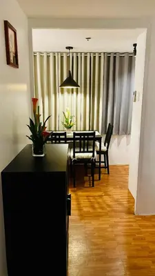 a living room with a table and a dining room at Modern Condo for Couple with Wi-Fi, Netflix & Kitchen, 1 min to MRT Boni in Manila