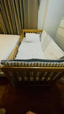 a wooden bed in a room with at Modern Condo for Couple with Wi-Fi, Netflix & Kitchen, 1 min to MRT Boni in Manila