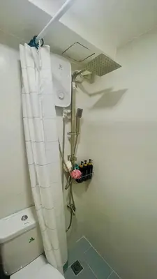 a shower in a bathroom with a toilet at Modern Condo for Couple with Wi-Fi, Netflix & Kitchen, 1 min to MRT Boni in Manila