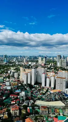 an aerial view of a city with tall buildings at Modern Condo for Couple with Wi-Fi, Netflix & Kitchen, 1 min to MRT Boni in Manila