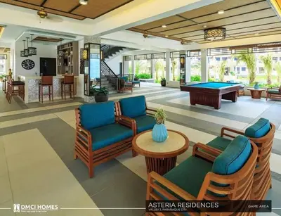 a living room with couches and a pool table at 3BR Resort Style Condo in Manila