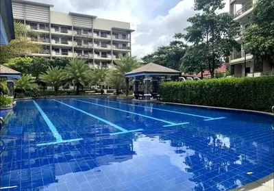 a large blue swimming pool in front of a building at 3BR Resort Style Condo in Manila