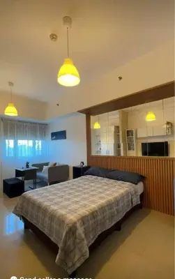 a bedroom with a bed and a living room at Overnight@ Light in Manila