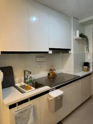 a kitchen with white cabinets and a sink at Overnight@ Light in Manila