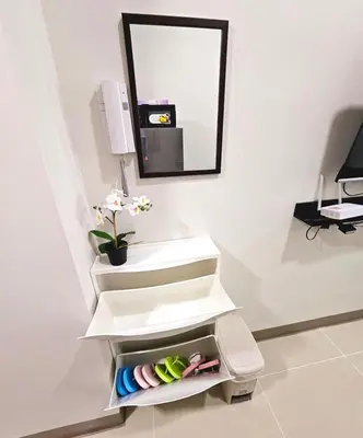 a bathroom with a white sink and a mirror at Cozy Two Bedroom Family Suites at Coast Residences near PICC, WTC & MOA in Manila
